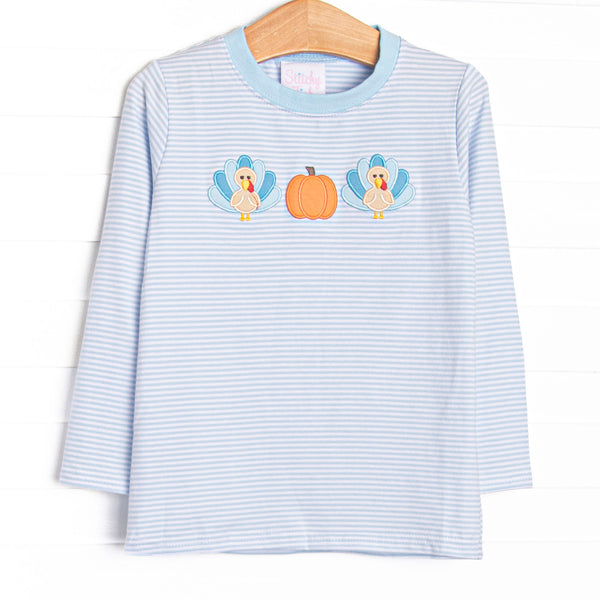 This top features light blue striped knit fabric, pumpkin and turkey applique, and long sleeves.
