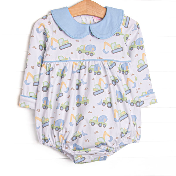 This bubble features a construction print, blue peter pan collar, and snaps on the stride to make changing a breeze.