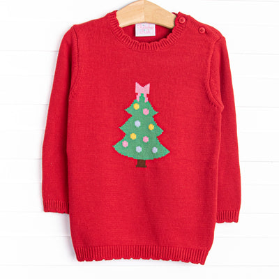  This sweater features a red knit material, buttons on the shoulder, and a Christmas tree icon. 