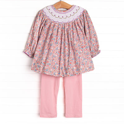 This set features a purple floral print, a floral smocking, and coordinating pink leggings to match.