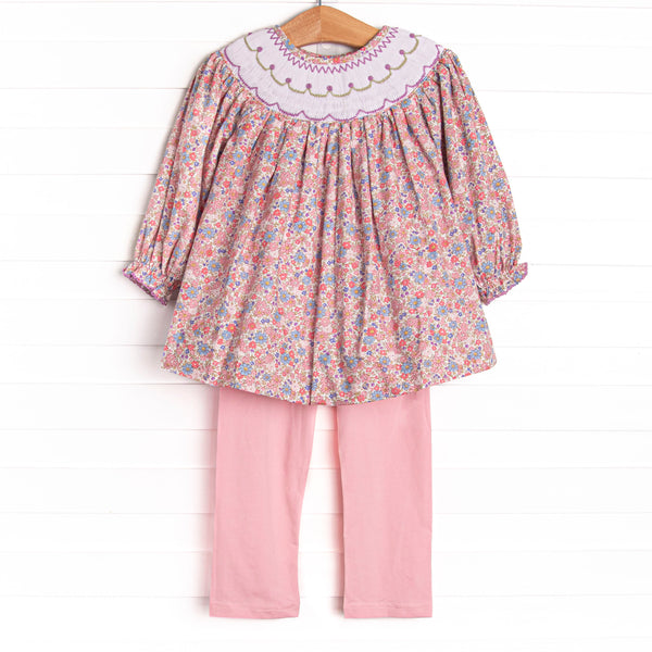 This set features a purple floral print, a floral smocking, and coordinating pink leggings to match.