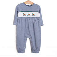This romper features navy striped fabric, duck smocking, and snaps along the stride to make changing a breeze.