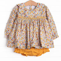This set features a yellow floral print, a scalloped collar, and a dainty smocking. Coordinating yellow diaper cover to match.
