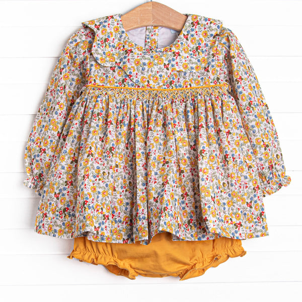 This set features a yellow floral print, a scalloped collar, and a dainty smocking. Coordinating yellow diaper cover to match.