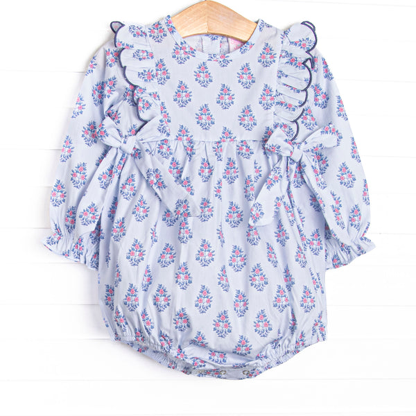  This bubble features a blue floral print, a scalloped flutter trim, and side bows. 