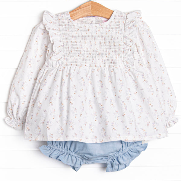 This set features a blue floral print, a dainty smocking, and flutter trim. Coordinating blue diaper cover to match.