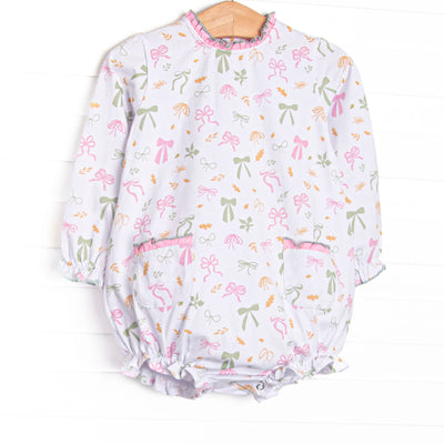  This bubble features a leaves and bows print, a pink ruffle neck, and ruffle front pockets. 