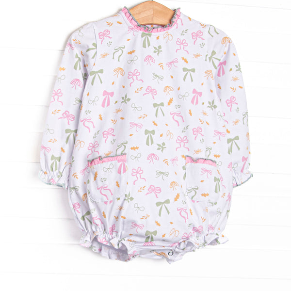  This bubble features a leaves and bows print, a pink ruffle neck, and ruffle front pockets. 