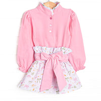 This set features a pink buttoned top, a ruffle neck, and a leaves and bows printed skirt with a tied waist.