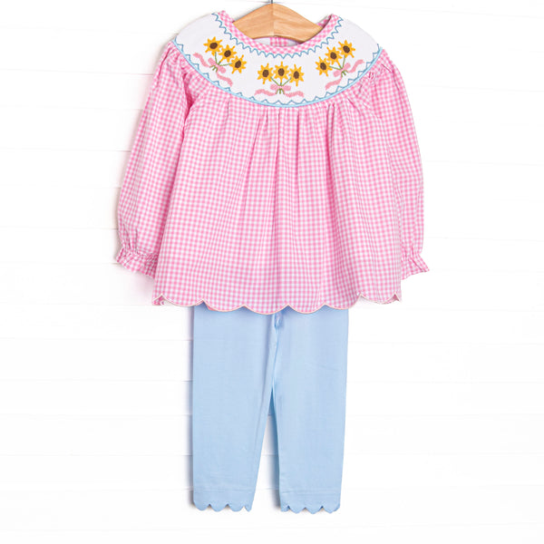  This set features pink gingham fabric, sunflower smocking, scallop trim, and long sleeves. Coordinating blue scalloped leggings to match. 
