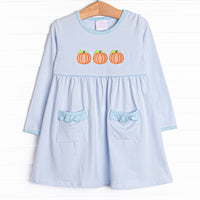  This dress features a blue striped print, front pockets, and a trio of pumpkins appliques. 