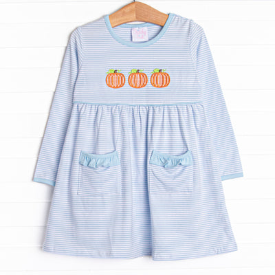  This dress features a blue striped print, front pockets, and a trio of pumpkins appliques. 