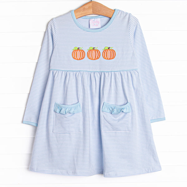  This dress features a blue striped print, front pockets, and a trio of pumpkins appliques. 