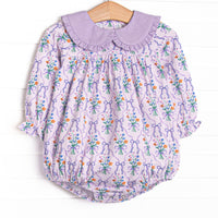  This bubble features a purple floral, a purple ruffle Peter Pan collar, and long sleeves. 