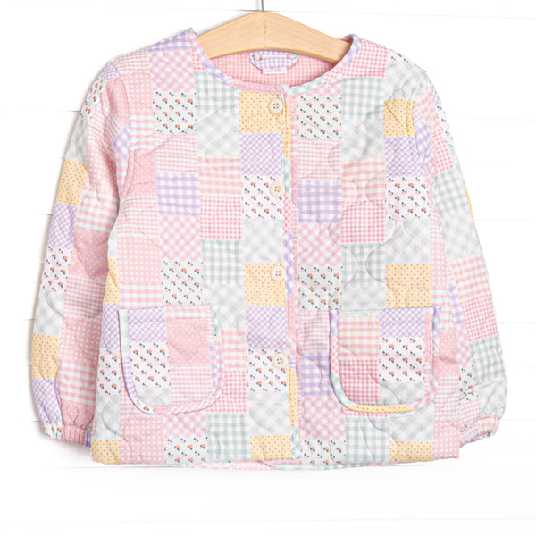 This coat features a pink quilt pattern, front buttons, and front pockets.