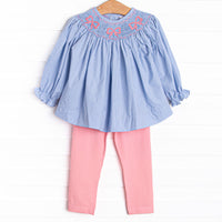 This set features a blue gingham print, bow smockings, and&nbsp; coordinating pink leggings to match.