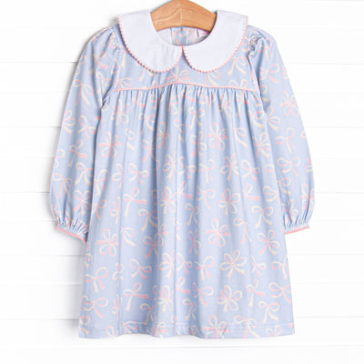  This dress features a bow print, a peter pan collar, and picot trim. 
