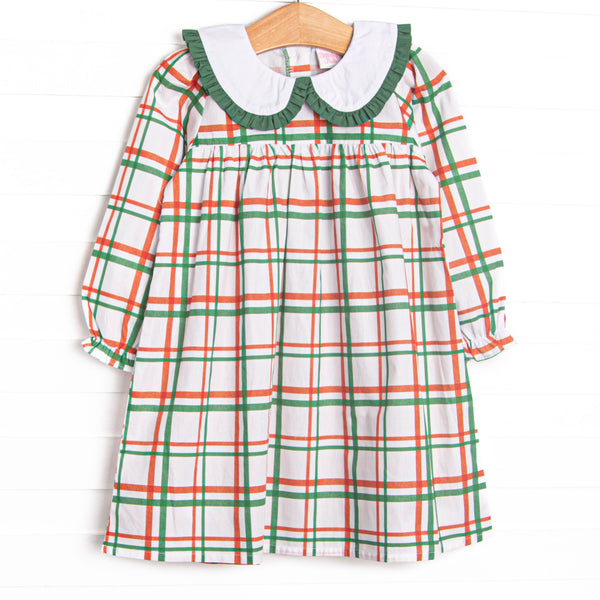  This dress features a red and green plaid, a peter pan collar, and green ruffle trim. 