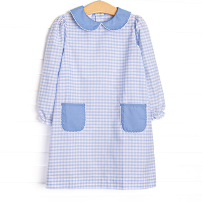 This dress features a blue plaid print, a blue peter pan collar, and blue front pockets.