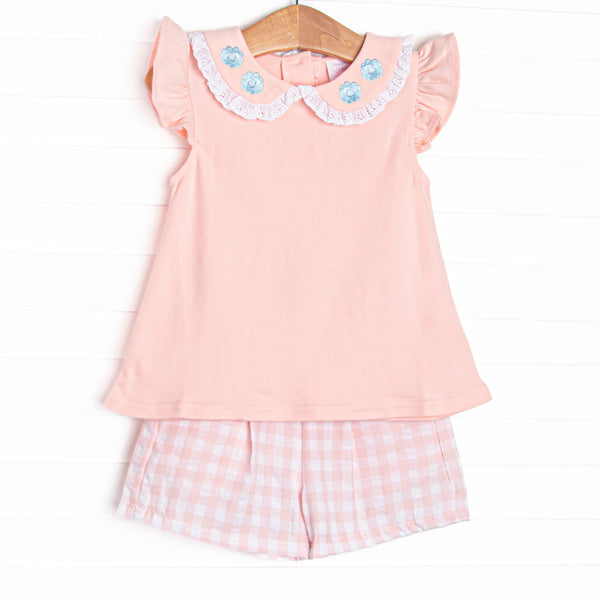  This set features a pink flutter sleeve top with a eyelet trimmed peter pan collar with floral embroidery. Coordinating pink check shorts to match. 