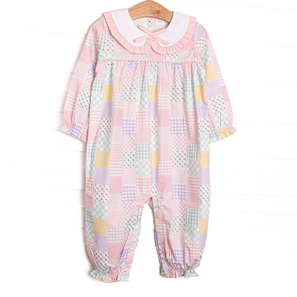  This romper features a pink quilt pattern, a ruffle Peter Pan collar, a pre tied bow, and snaps along the side to make changing a breeze. 