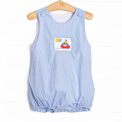  This bubble features a blue gingham print, front covered buttons and&nbsp; a steamboat smocking. 