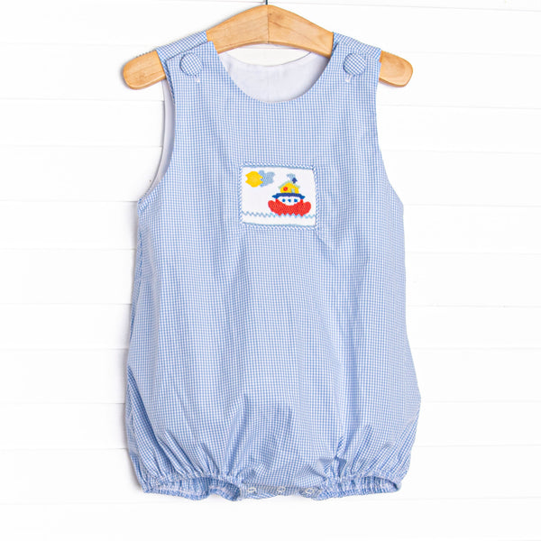  This bubble features a blue gingham print, front covered buttons and&nbsp; a steamboat smocking. 
