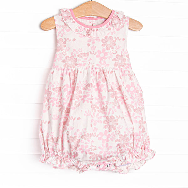  This bubble features a pink floral print, ruffle collar, and a bow sash on the back. 