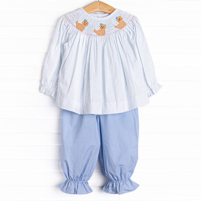 This set features a blue bitty dot top with a trio of puppies smocking, and blue gingham bloomer pants to match.