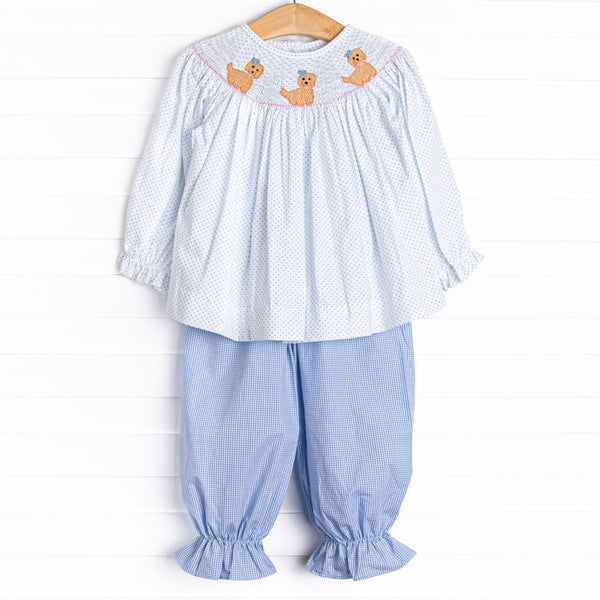 This set features a blue bitty dot top with a trio of puppies smocking, and blue gingham bloomer pants to match.