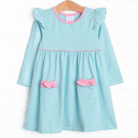  The dress features front ruffle pockets, mint stripes, and the softest knit material. 