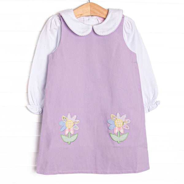 This set features a purple pique dress, a white top, a Peter Pan collar, and floral applique.
