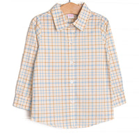  This top features a blue plaid print, a polo collar, and a button down front. 