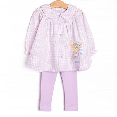 This set features purple gingham fabric, a Peter Pan collar, a little girl applique, and front buttons. Coordinating purple leggings to match.