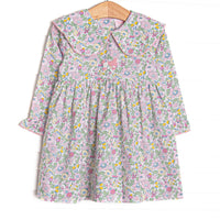 This dress features a pink flower print, a picot trimmed bib collar, and a French knot poodle embroidery.