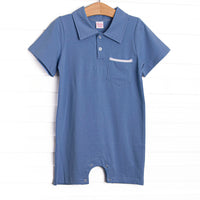 This romper features a blue knit material, front pocket, and a polo collar.