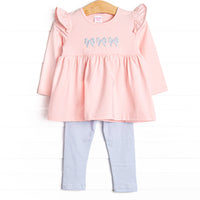  This set features a pink material, a trio of blue bow embroidery, and blue striped leggings to match. 
