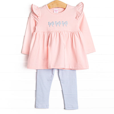 This set features a pink material, a trio of blue bow embroidery, and blue striped leggings to match. 