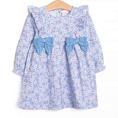  This dress features&nbsp; a blue floral print, a flutter trim, and blue polka bows. 