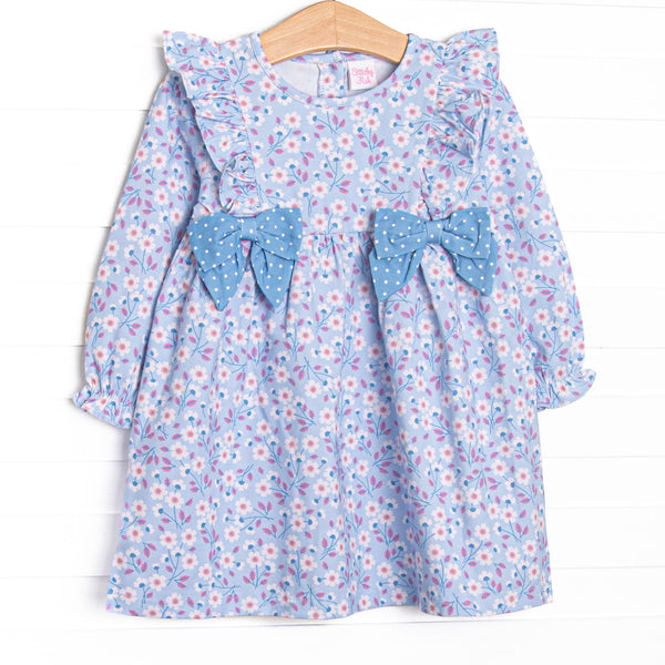  This dress features&nbsp; a blue floral print, a flutter trim, and blue polka bows. 
