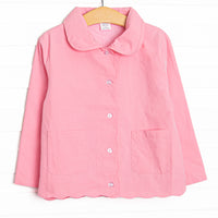  This coat features a pink material, a peter pan collar and trim, and scalloped trim. 