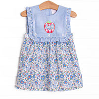  This dress features a blue floral print, a blue gingham button on bib, and red apple applique with ABC's on top. 
