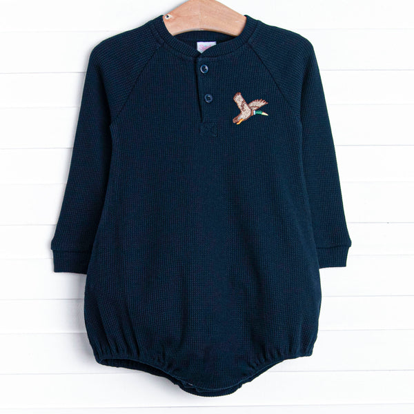  This bubble features a navy blue waffle knit material, front buttons, and a mallard embroidery. 