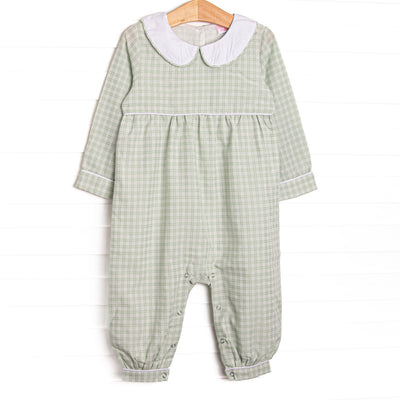  This romper features a green plaid print, a peter pan collar, and snaps on the stride. 