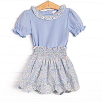  This set features a blue shirt with puff sleeves and blue floral ruffle collar. Coordinating blue floral scalloped trim skirt to match. 