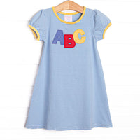 This dress features a blue stripe pattern, yellow trim, and ABC applique.