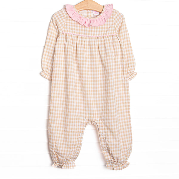 This romper features a tan gingham print, a pink ruffle collar, and snaps on the stride.