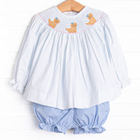 This set features a blue bitty dot top with a trio of puppies smocking and blue gingham bloomer shorts to match.