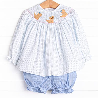 This set features a blue bitty dot top with a trio of puppies smocking and blue gingham bloomer shorts to match.