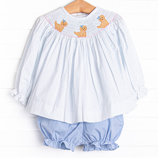 This set features a blue bitty dot top with a trio of puppies smocking and blue gingham bloomer shorts to match.